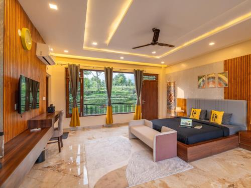 a bedroom with a bed and a living room at The Hosteller Bam Bir in Bīr