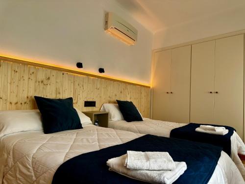 a hotel room with two beds with towels on them at Hostal J&C in Olula del Río