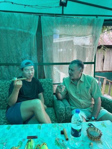 a man and a woman sitting on a couch at Green view group of houseboats in Srinagar