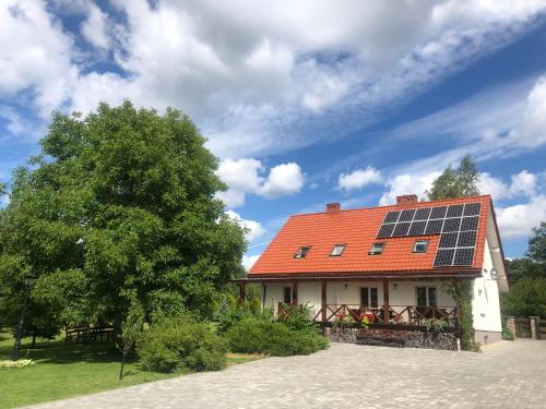 a house with solar panels on the roof at Raciborówka in Świętajno