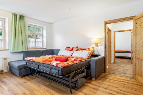 a bedroom with a bed and a couch at Zeitlos Wriezen 1 in Wriezen