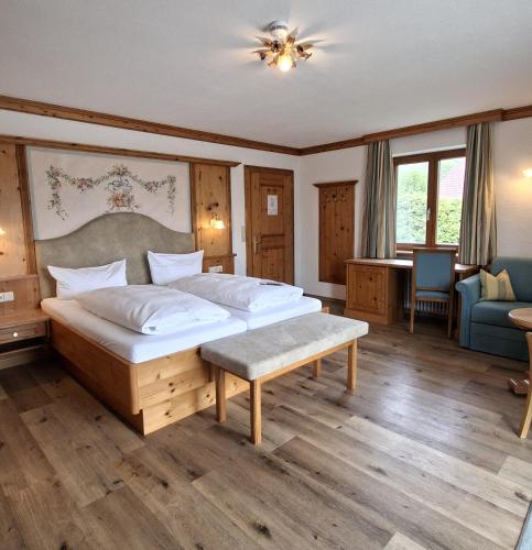 a bedroom with a large bed in a room at Hotel Gasthof Jägerhaus in Sankt Peter