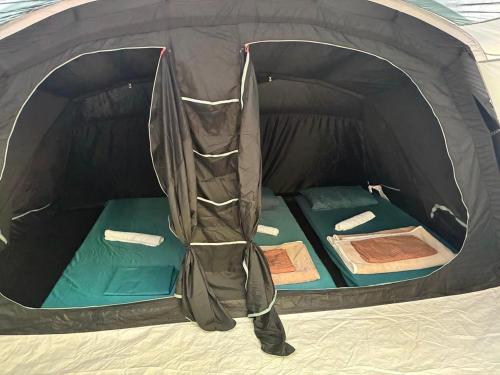 a black tent with the door open on the inside at Gio Camping Shala River in Mollʼ e Shoshit