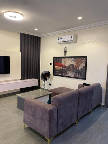 a living room with two couches and a tv at Sandton Luxury Apartment in Bardon Yana