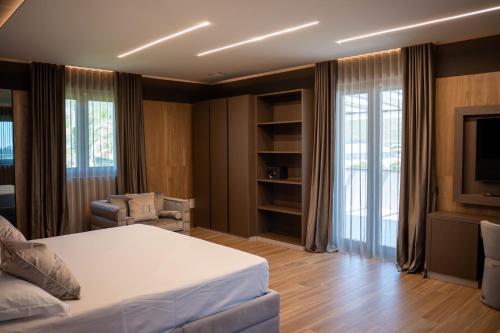 a bedroom with a bed and a tv in a room at Tre Fontane Country House in Sperlonga