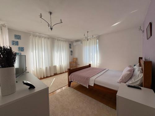 a bedroom with a bed and a television in it at Home Medicci in Bihać