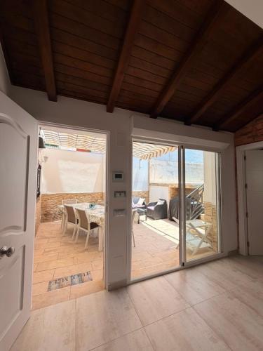 an open door to a patio with a table at Villa Wilecris in Punta Umbría