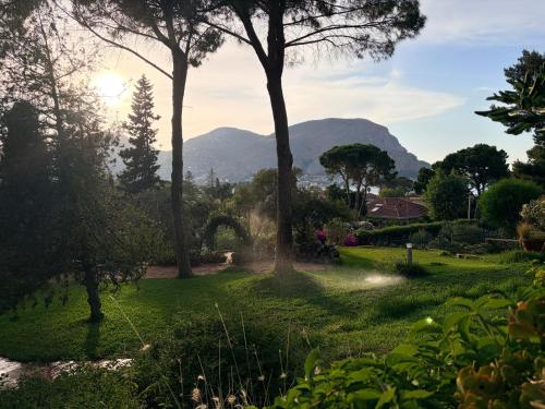 a view of a garden with mountains in the background at Park House in Mondello