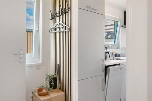 a kitchen with a white refrigerator and a sink at Peter Pan in Dörverden
