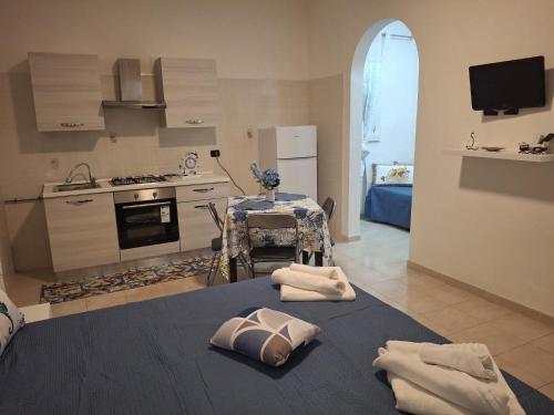 a kitchen with a table with two towels on it at Costa Marina in Marsala