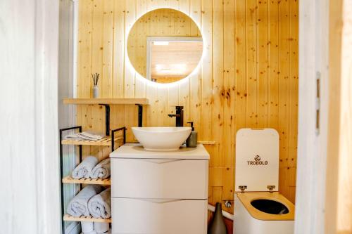 a bathroom with wooden walls and a sink at Domček Lazy in Štôla