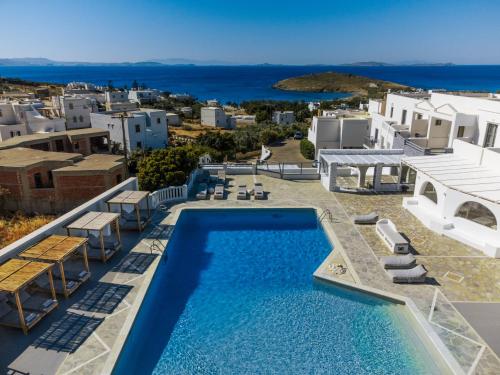 a villa with a pool and a view of the ocean at Mr and Mrs White Tinos in Tinos