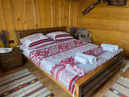 a bed with pillows on it in a room at Погарь Квасівський in Kvasy