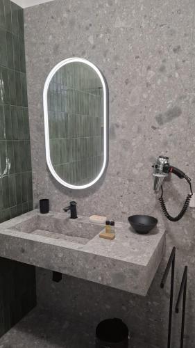 a bathroom with a sink and a mirror at Mansio Pegaso in Tivoli