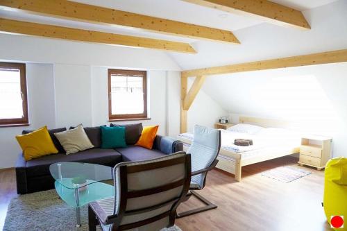 a living room with a couch and a table at Rovenská Chalupa in Strážov