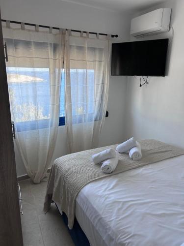 a bedroom with a bed with towels on it at Smaragda's Studio in Kithnos