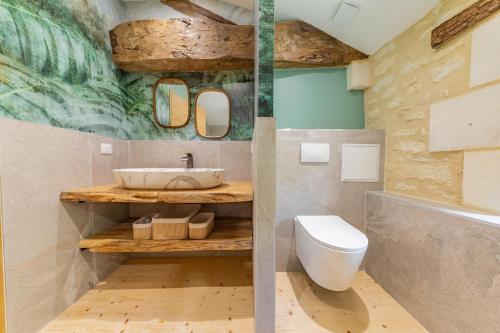 a bathroom with a sink and a toilet at La Châtellerie du Gagnon in Champagnolles