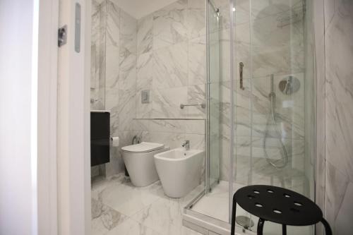 a bathroom with a toilet and a glass shower at Dimora del mare in Agropoli