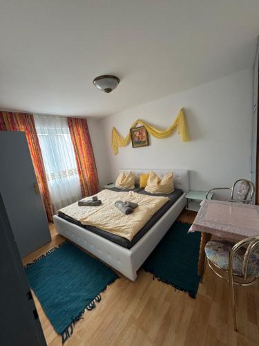 a bedroom with a bed and a table at Guesthouse Mother in Sielach