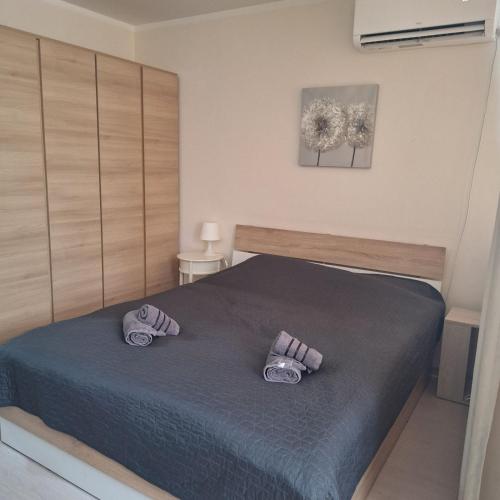 a bedroom with a bed with two slippers on it at COSY and SPACIOUS APARTMENT C30 in Borovetz in Borovets