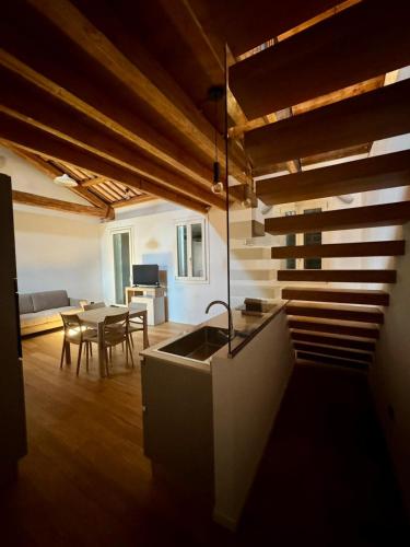 a kitchen and living room with a sink and a table at ERMAN HOUSE - Dimora del Doge in Dolo