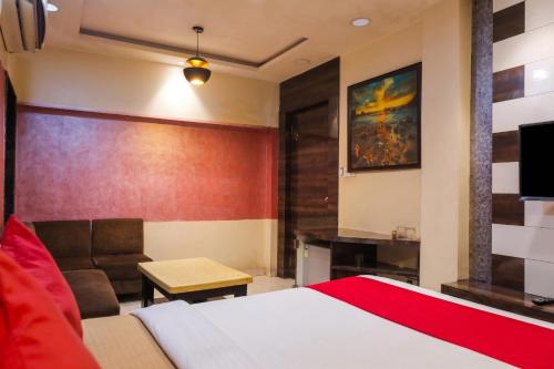 a hotel room with a bed and a couch at Abis Inn -Ballygunge in Kolkata