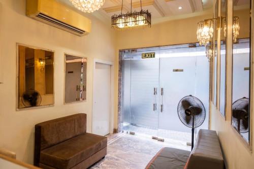 a living room with a couch and a glass door at Abis Inn -Ballygunge in Kolkata