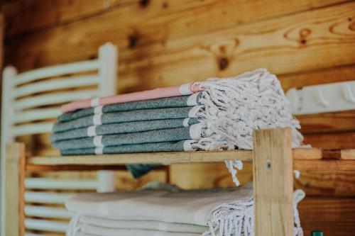 a pile of towels sitting on a wooden shelf at Hanul Morii in Ciucea