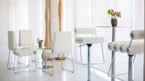a group of white chairs sitting in a room at Hotel English Point Marina & Spa in Mombasa