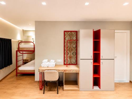 a room with a desk and a bunk bed at Valbona Resort & Spa in Valbonë