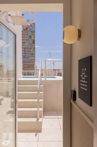 a view from the hallway of a building with stairs at Líbere Alicante Rambla in Alicante