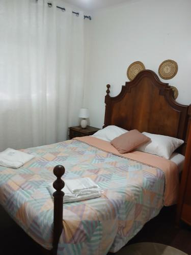 a bedroom with a bed with a laptop on it at Kannon 1 5-minute walk to all transport options at the Pragal terminal in Caparica
