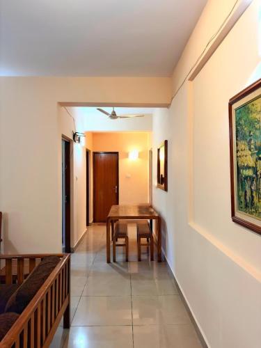 a dining room with a table and a couch at Siolim Serenity in Siolim