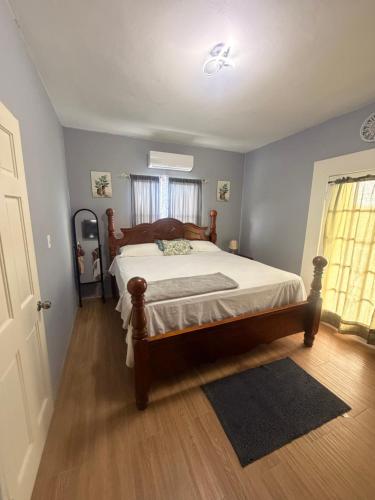 a bedroom with a large bed in a room at Sunfusion apartment & Cottages in Saint Mary