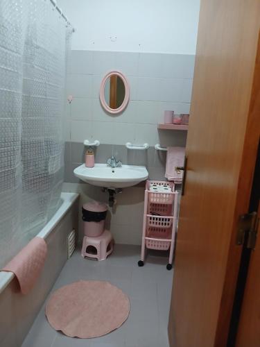 a bathroom with a sink and a bath tub and a sink at Kannon 1 5-minute walk to all transport options at the Pragal terminal in Caparica