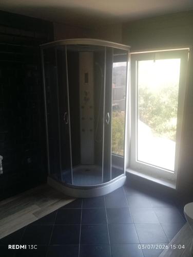 a bathroom with a shower next to a window at Telhadosolitario in São Pedro da Cova