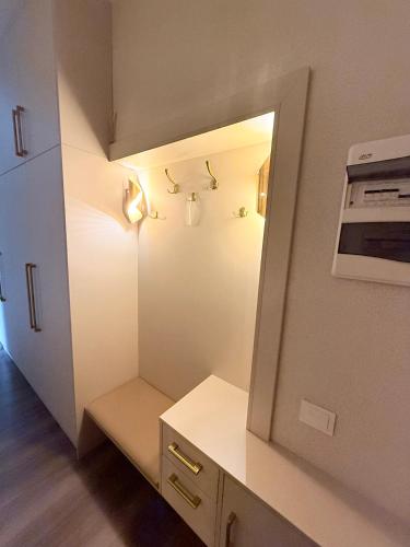 a small kitchen with a mirror and a sink at 2 room central apartment in Jelgava