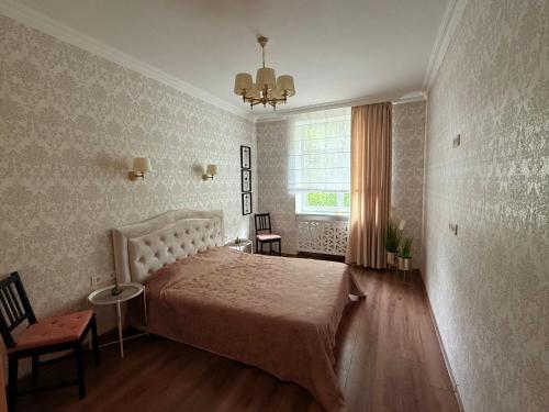 a bedroom with a large bed and a window at 2 room central apartment in Jelgava