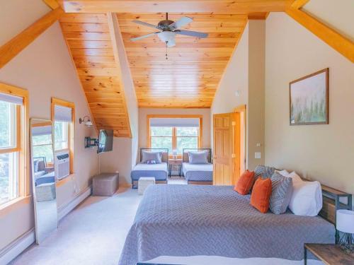 a bedroom with a bed and a ceiling fan at Peaceful Winnipesaukee Retreat, Walking Trails in Wolfeboro