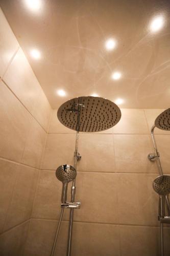 a bathroom with a shower with two stools at Exclusive 1 bedroom apartment in Copenhagen