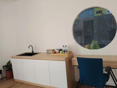 a kitchen with a sink and a mirror at Shira Villa in Seturan