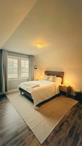a bedroom with a large bed and a window at Hamilton Central 3BR Family House in Hamilton