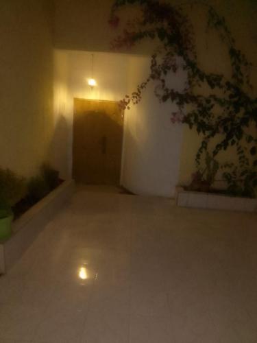 an empty room with a door and a wall with flowers at Paradise maison d'hôte in Nouakchott