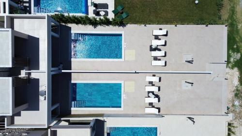 an overhead view of a building with two swimming pools at The Serata Villas 2 in Hanioti