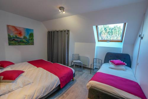 a bedroom with two beds and a window at Hôtel Restaurant Ardesia in Peyrelevade