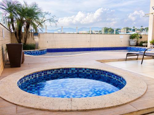 a pool on a patio with a table and a bench at Ville de Montagne Hotel in Brumadinho