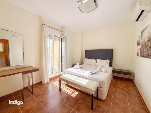 a bedroom with a bed and a table and a mirror at Beachfront Apartment - Sea View - COU02 in Ayamonte