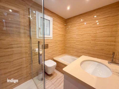 a bathroom with a toilet and a sink and a shower at Beachfront Apartment - Sea View - COU02 in Ayamonte