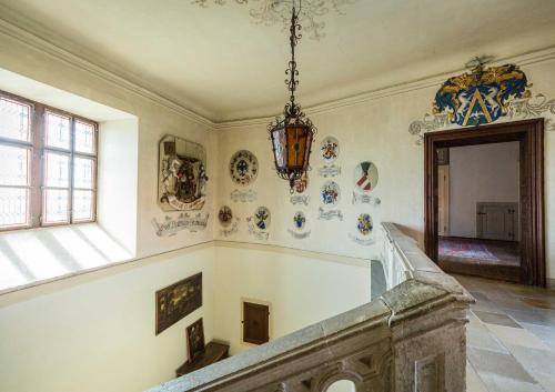 a staircase in a building with plates on the wall at Burg Bernstein in Bernstein