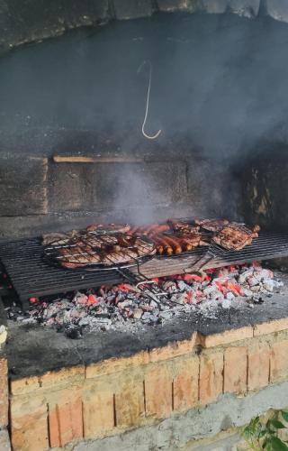 a grill with a bunch of food on it at Vila Stancevic wellness in Sremski Karlovci